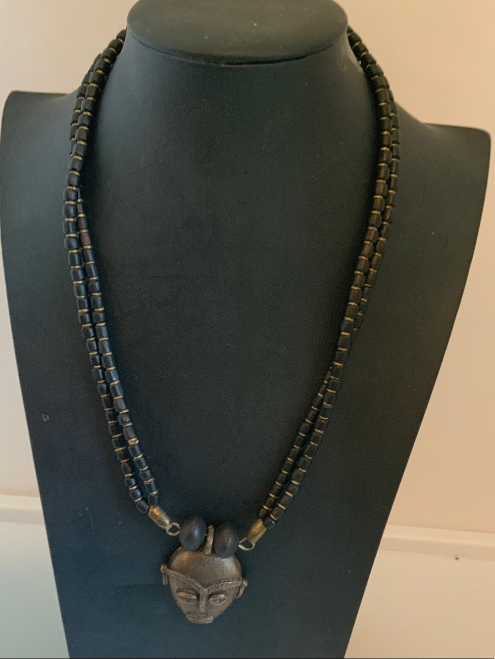 Black Beaded Necklace with Antique Gold Tribal Mask Pendant